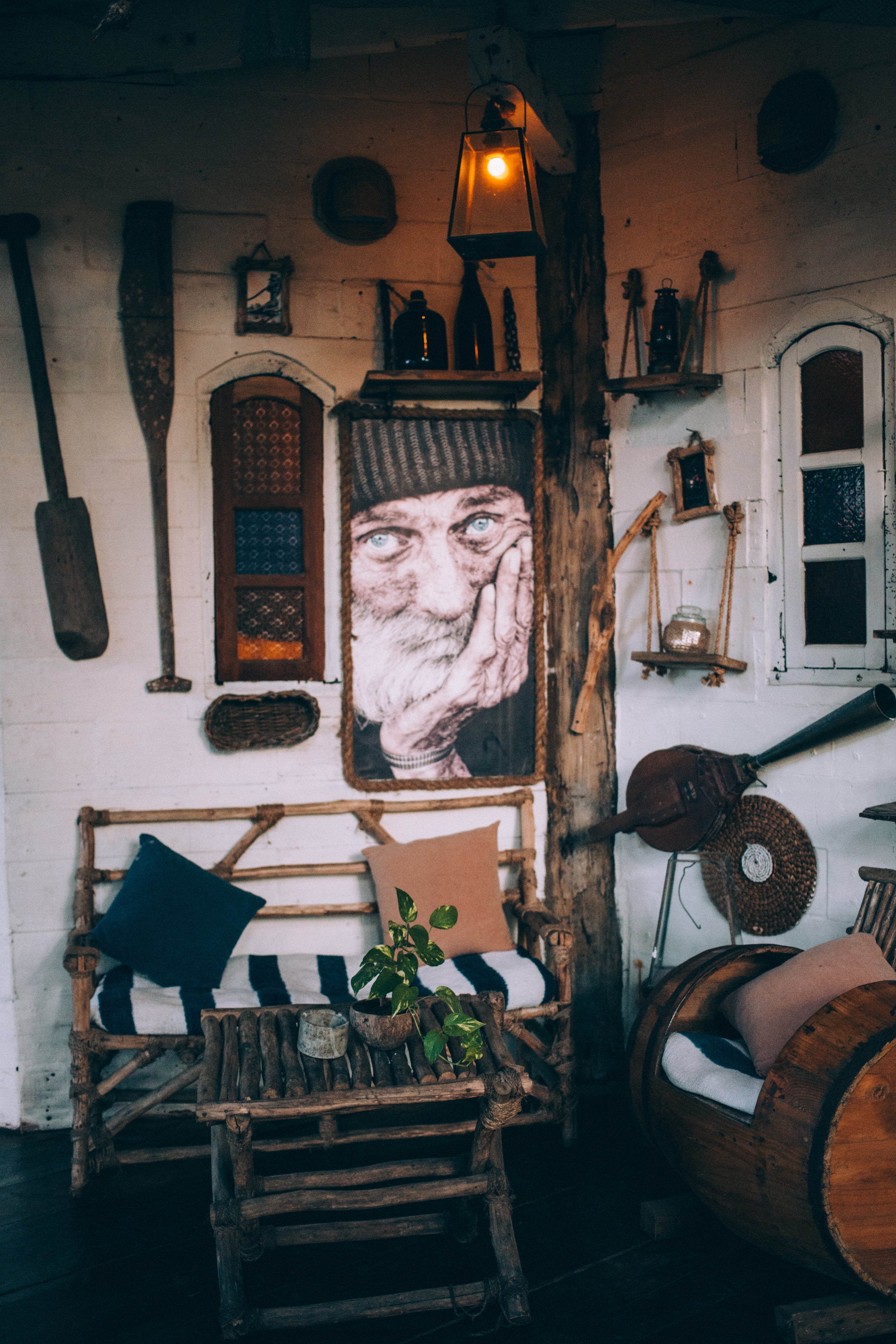 A vignette of rustic artifacts and decor featuring an inner image of a contemplative old salt figure.